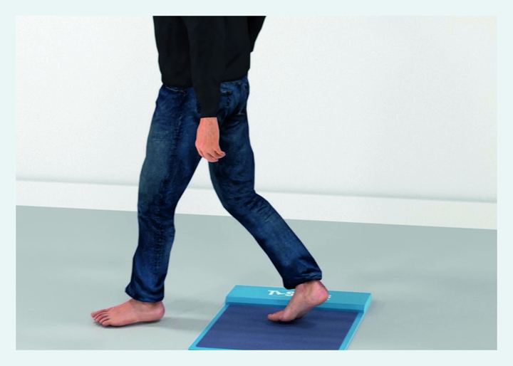 Patient walking over the T-Soles pressure plate
